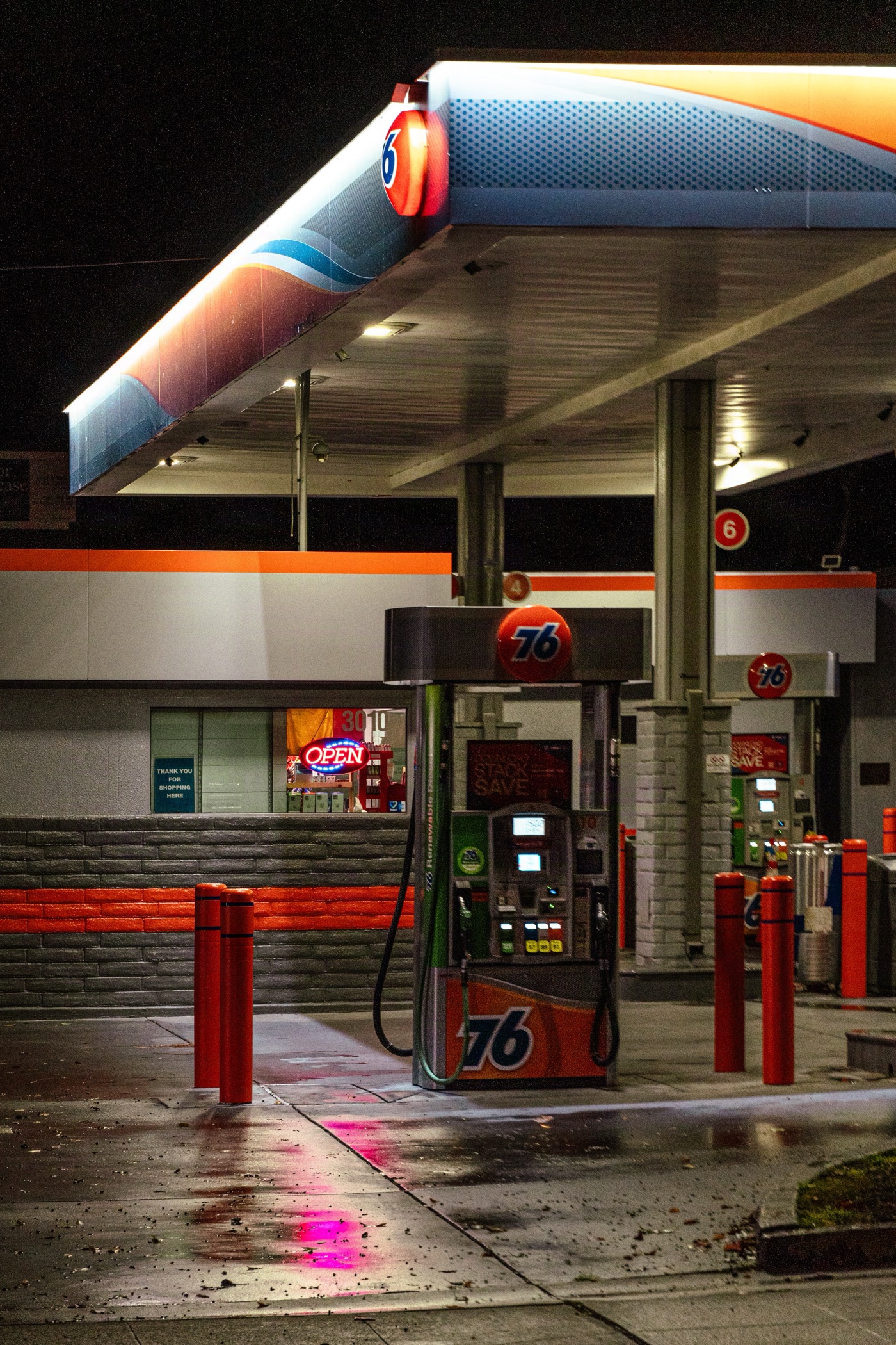 A gas station forecourt lit at night for a commercial client
